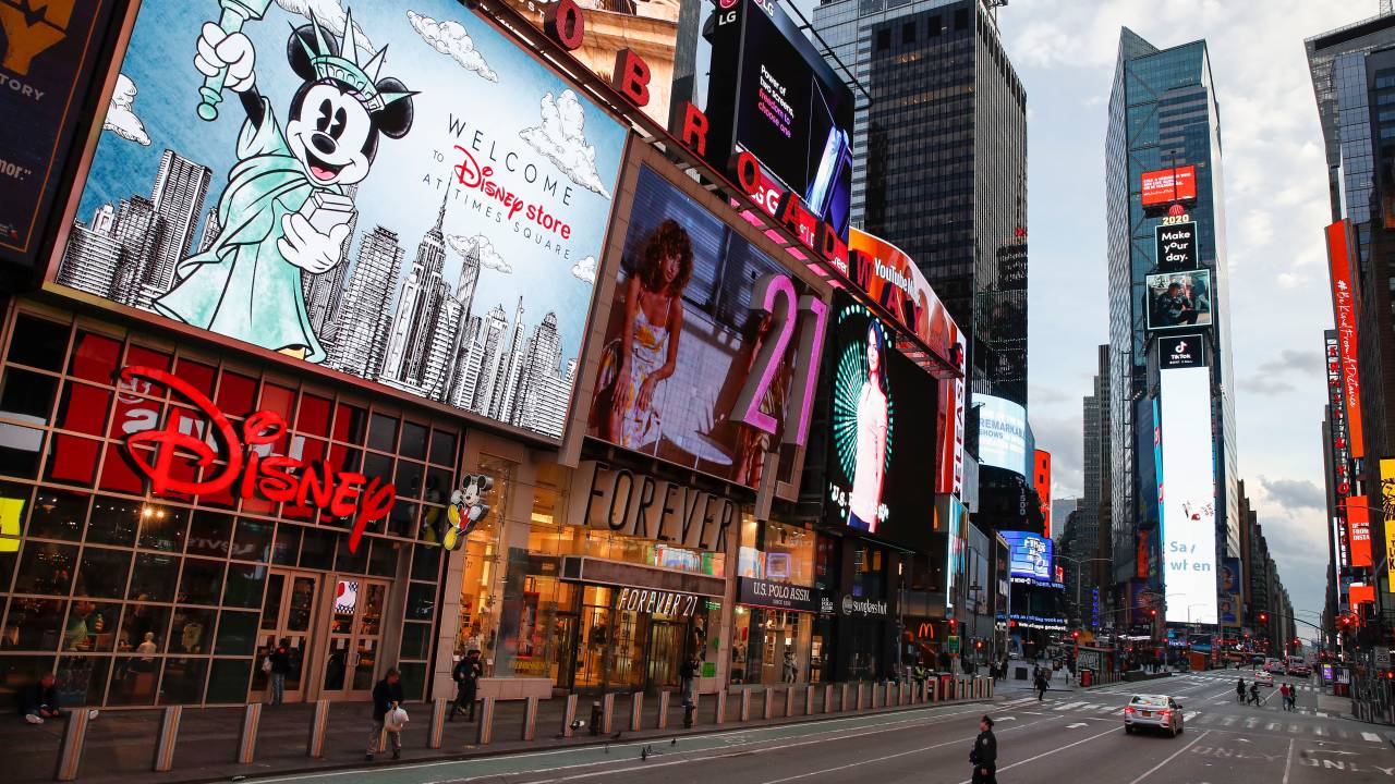 Policial cruza a 7ª Avenida na Times Square, ponto turístico da cidade de Nova York, geralmente lotado - 20/03/2020