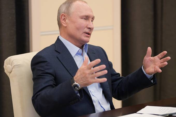 Russian President Vladimir Putin attends a meeting  via a video link outside Moscow
