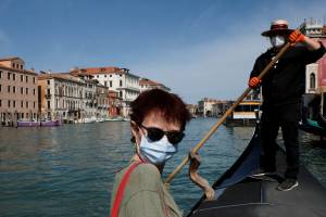 Gondoliers resume their service on the Grand Canal as Italy eases some more of the lockdown measures put in place during the coronavirus disease (COVID-19) outbreak, in Venice