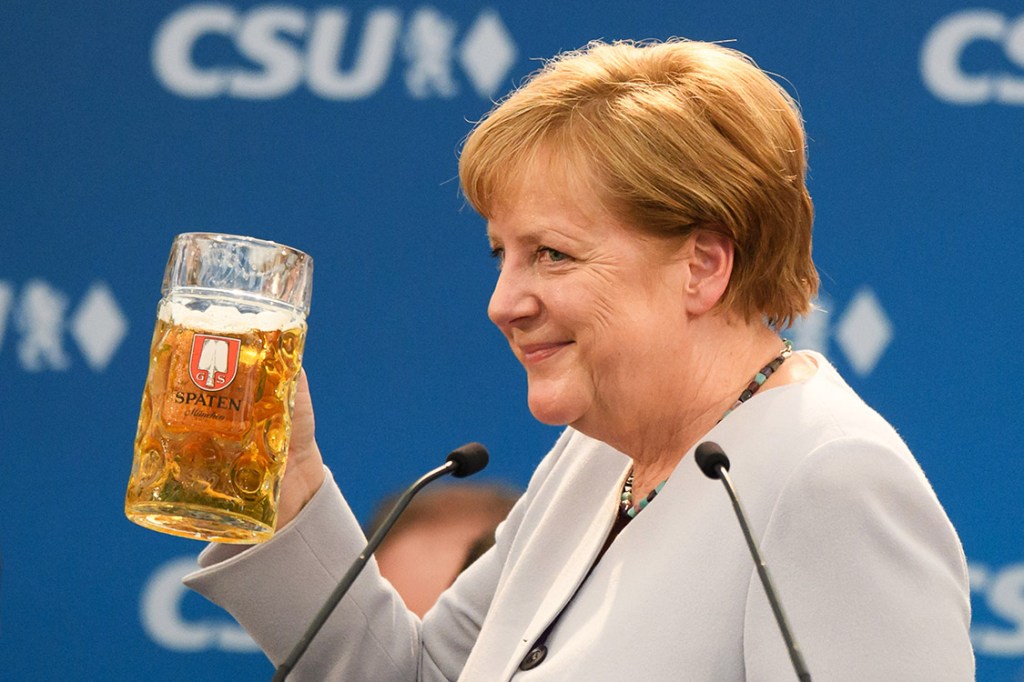 MUNICH, GERMANY - MAY 28: German Chancellor and Chairwoman of the German Christian Democrats (CDU) Angela Merkel holds a beer mug after her speech at the Trudering fest on May 28, 2017 in Munich, Germany. The CDU and CSU, along with the German Social Democrats (SPD), form the current German coalition government, though relations between Merkel and Seehofer have been complicated as the two have clashed over certain issues, especially immigration. (Photo by Sebastian Widmann/Getty Images)