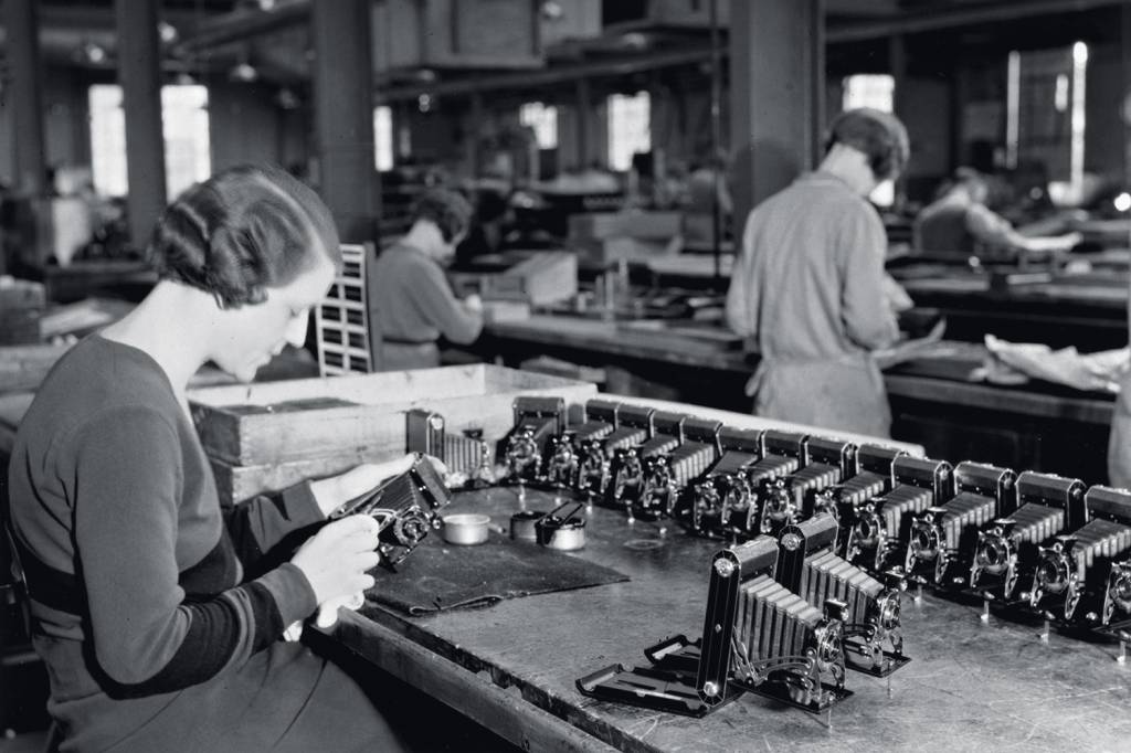 Production line worker assembling a Kodak c Production line worker assembling a Kodak c