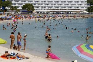 People enjoy Magaluf beach in Mallorca