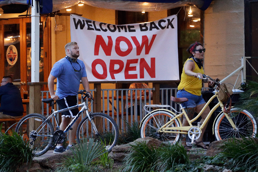Ciclistas passam por restaurante em San Antonio, Texas