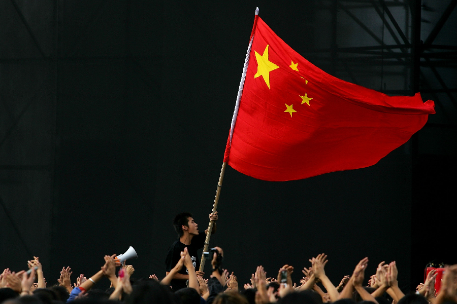 Chinese teenager waves a national flag - China