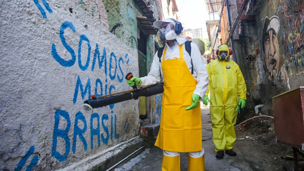 NITEROI, BRAZIL - MARCH 25: Agents of the sanitary department clean streets and alleys of the Vila Ipiranga Favela, in Fonseca neighborhood on March 25, 2020 in Niteroi, Brazil. Vila Ipiranga is the first community (Favela) in the country to receive the visit of sanitary agents using the same technology applied in China to help prevent the spreading of the coronavirus (COVID-19). According to the Ministry of health, as of today, Brazil has 2271 confirmed cases infected with the coronavirus (COVID-19) and at least 47 recorded deceases. (Photo by Luis Alvarenga/Getty Images)