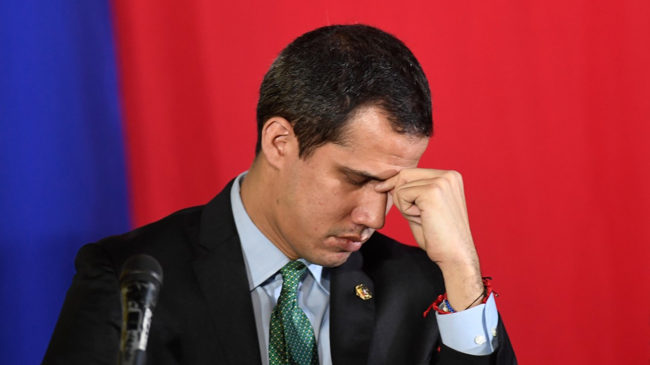(FILES) In this file photo taken on February 18, 2020 Venezuelan opposition leader and self-proclaimed acting president Juan Guaido gestures during a plenary session of the National Assembly at the San Antonio municipal theatre in San Antonio de Los Altos south of Caracas. - A new Venezuelan parliament will be sworn in on January 5, 2021 with the party of President Nicolas Maduro now in almost complete control and the main thorn in his side, Western-backed opposition leader Juan Guaido, out in the political cold. (Photo by Federico PARRA / AFP)