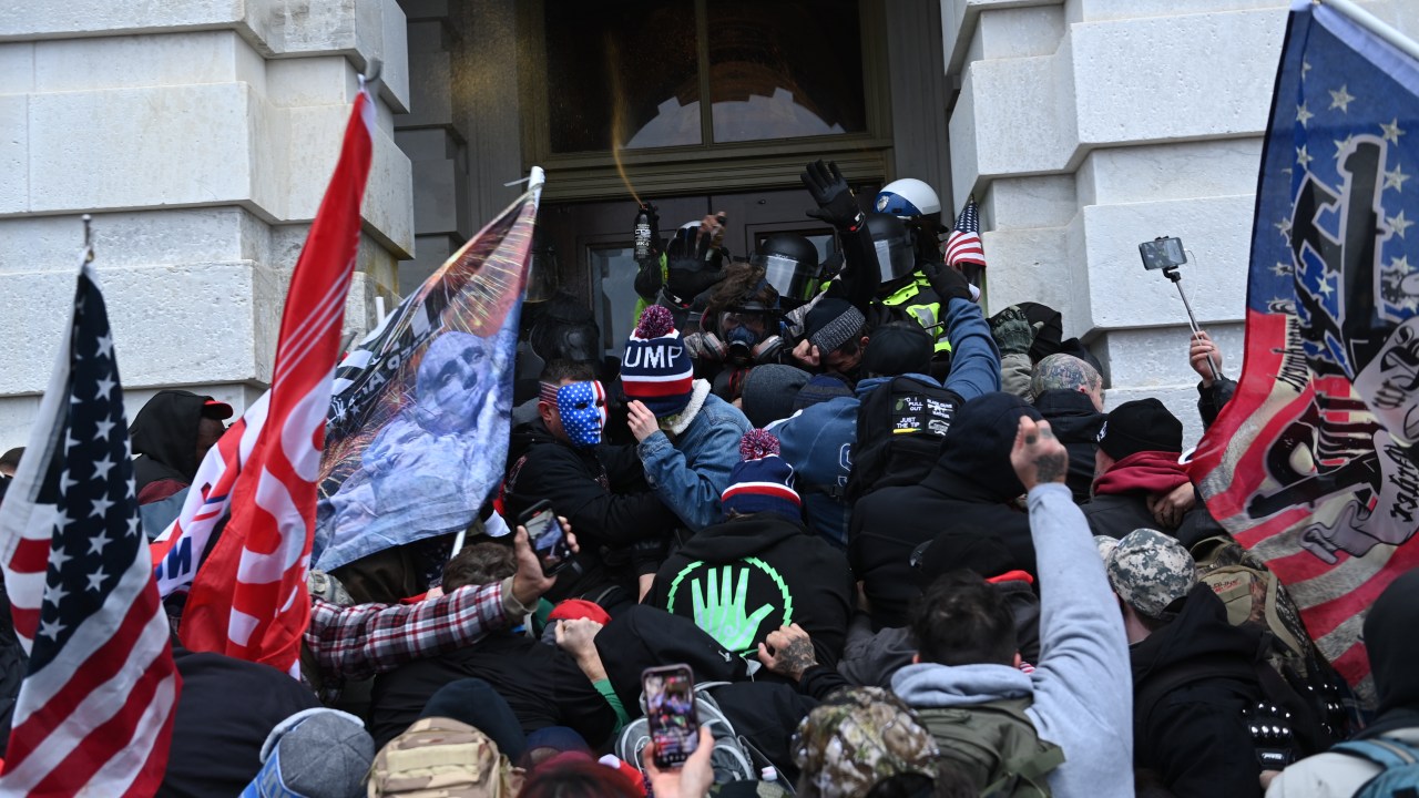 Apoiadores do presidente Donald Trump em confronto com policiais e membros das forças de segurança durante invasão ao Capitólio, Washington. 06/01/2021