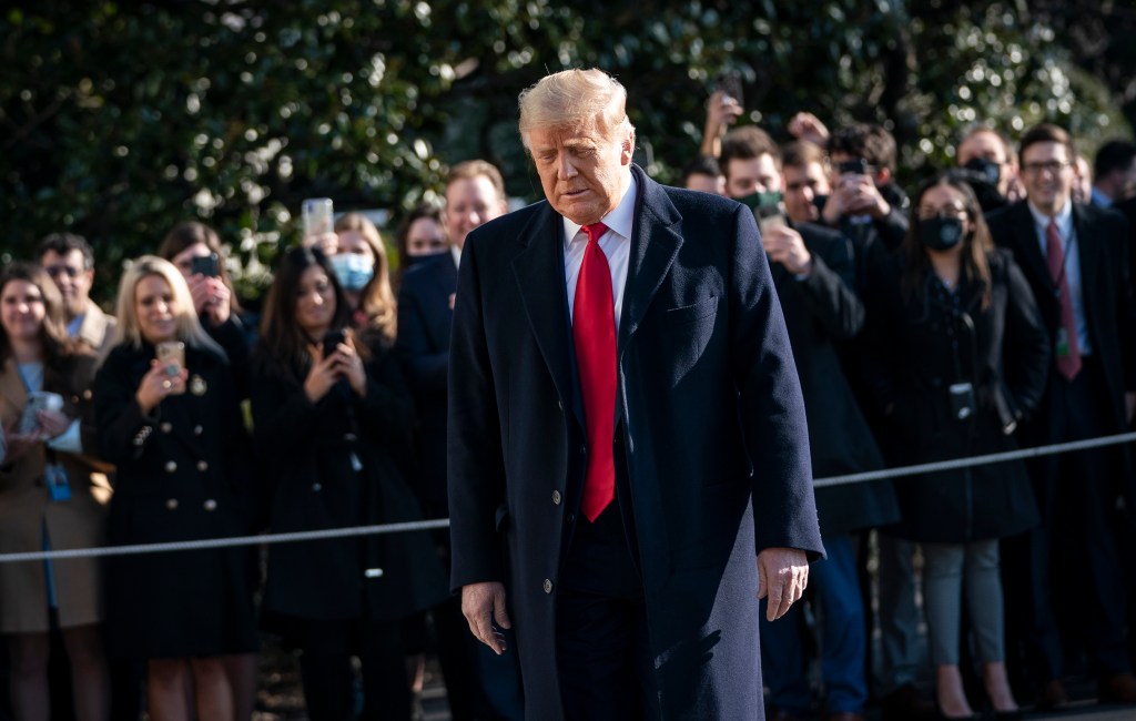WASHINGTON, DC - JANUARY 12: U.S. President Donald Trump turns to reporters as he exits the White House to walk toward Marine One on the South Lawn on January 12, 2021 in Washington, DC. Following last week's deadly pro-Trump riot at the U.S. Capitol, President Trump is making his first public appearance with a trip to the town of Alamo, Texas to view the partial construction of the wall along the U.S.-Mexico border. Drew Angerer/Getty Images/AFP