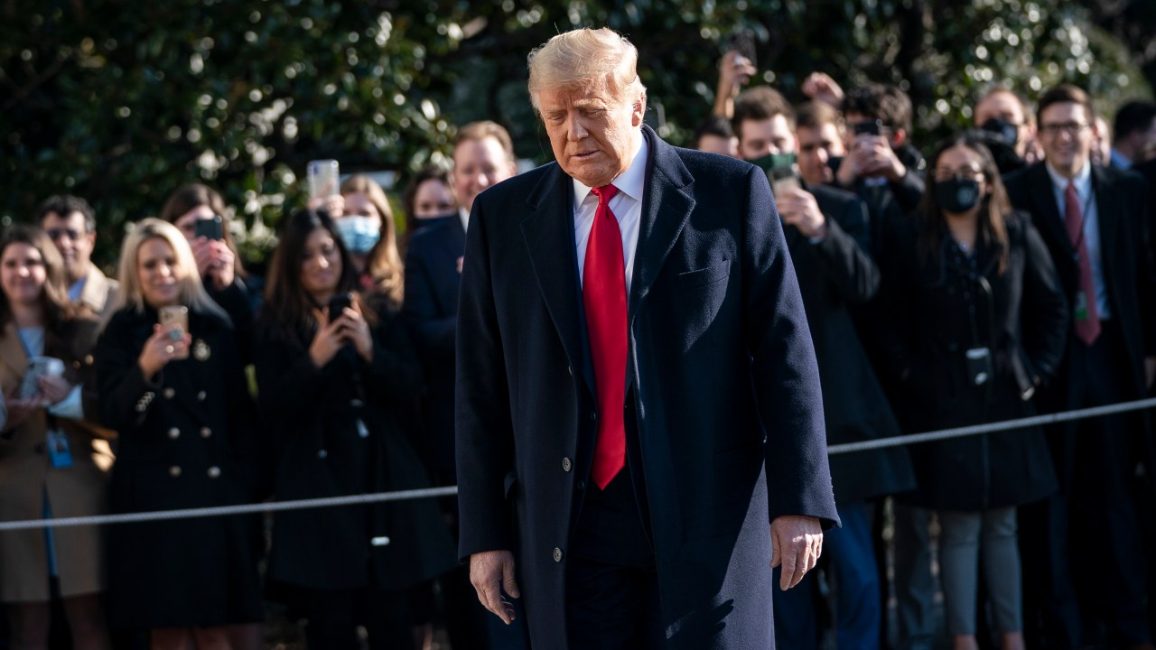 WASHINGTON, DC - JANUARY 12: U.S. President Donald Trump turns to reporters as he exits the White House to walk toward Marine One on the South Lawn on January 12, 2021 in Washington, DC. Following last week's deadly pro-Trump riot at the U.S. Capitol, President Trump is making his first public appearance with a trip to the town of Alamo, Texas to view the partial construction of the wall along the U.S.-Mexico border. Drew Angerer/Getty Images/AFP