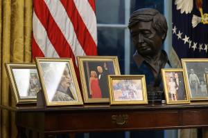 WASHINGTON, DC - JANUARY 20: A sculpted bust of Cesar Chavez is seen with a collection of framed photos on a table as U.S. President Joe Biden prepares to sign a series of executive orders at the Resolute Desk in the Oval Office just hours after his inauguration on January 20, 2021 in Washington, DC. Biden became the 46th president of the United States earlier today during the ceremony at the U.S. Capitol. Chip Somodevilla/Getty Images/AFP