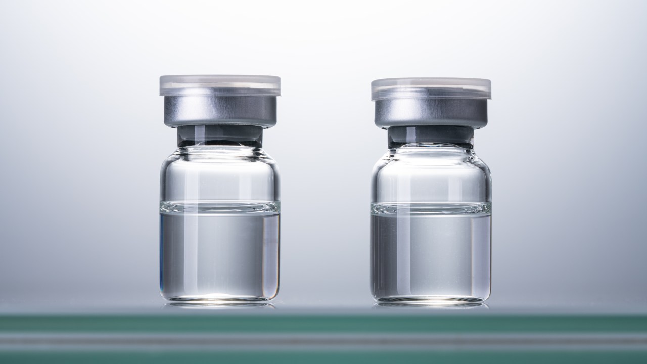 Two Sealed Airtight Medical Vials Against Bright Background Front View.