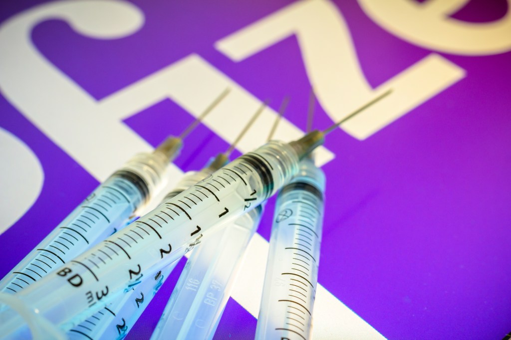 .BRAZIL - 2020/12/13: In this photo illustration, various medical syringes seen displayed on a screen with the Pfizer company logo in the background. (Photo Illustration by Rafael Henrique/SOPA Images/LightRocket via Getty Images)