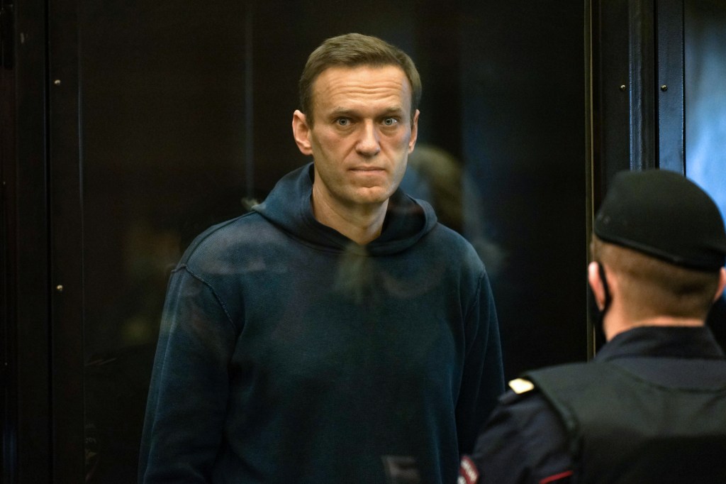 Russian opposition leader Alexei Navalny, charged with violating the terms of a 2014 suspended sentence for embezzlement, stands inside a glass cell during a court hearing in Moscow on February 2, 2021. (Photo by Handout / Moscow City Court press service / AFP) / RESTRICTED TO EDITORIAL USE - MANDATORY CREDIT "AFP PHOTO / Moscow City Court press service / handout" - NO MARKETING - NO ADVERTISING CAMPAIGNS - DISTRIBUTED AS A SERVICE TO CLIENTS