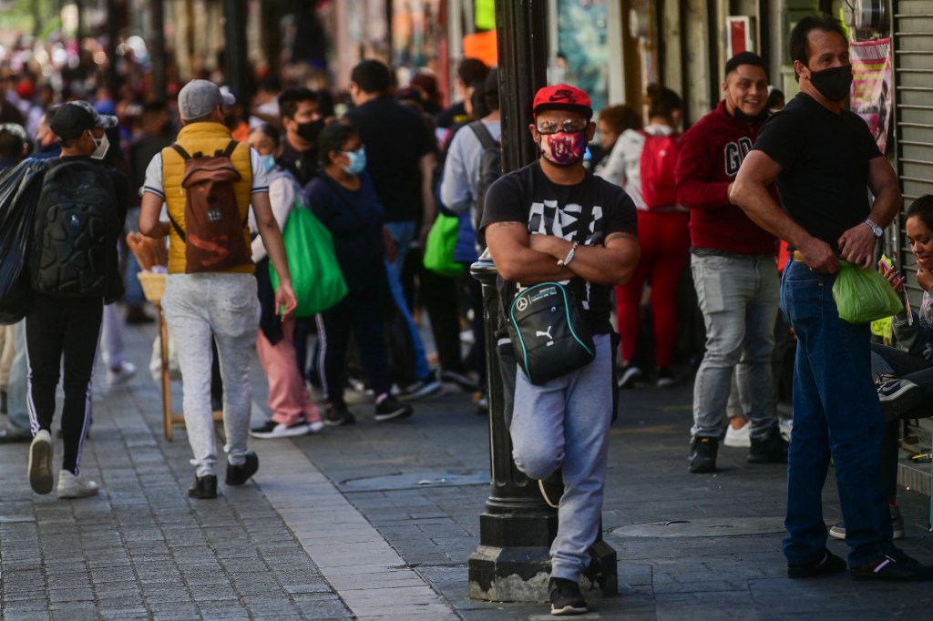 People are seen in downtown Mexico City, on February 3, 2021, amid the new coronavirus pandemic. - In spite of the deadly upsurge of the COVID-19, necessity pushes millions of Mexicans to the streets. (Photo by Pedro PARDO / AFP)