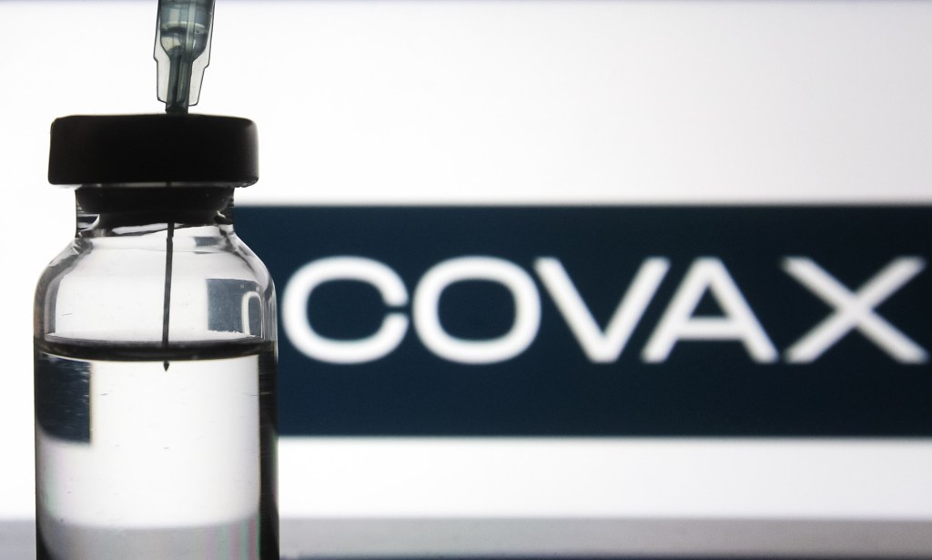 A medical syringe and a vial in front of the COVAX word are seen in this creative illustrative photo. More than one hundred fifty COVID-19 coronavirus vaccine are in development across the world, several of which have the third phase of clinical trials, as media reported. (Photo illustration by STR/NurPhoto via Getty Images)
