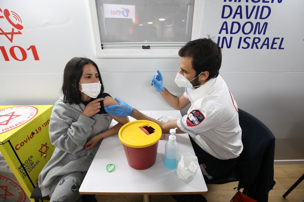 TEL AVIV, ISRAEL - FEBRUARY 18: Israeli youths receive coronavirus (Covid-19) vaccine within the scope of the campaign, free non-alcoholic drinks of various types were distributed to those who came to be vaccinated at the center in Tel Aviv, Israel on February 18, 2021. (Photo by Mostafa Alkharouf/Anadolu Agency via Getty Images)
