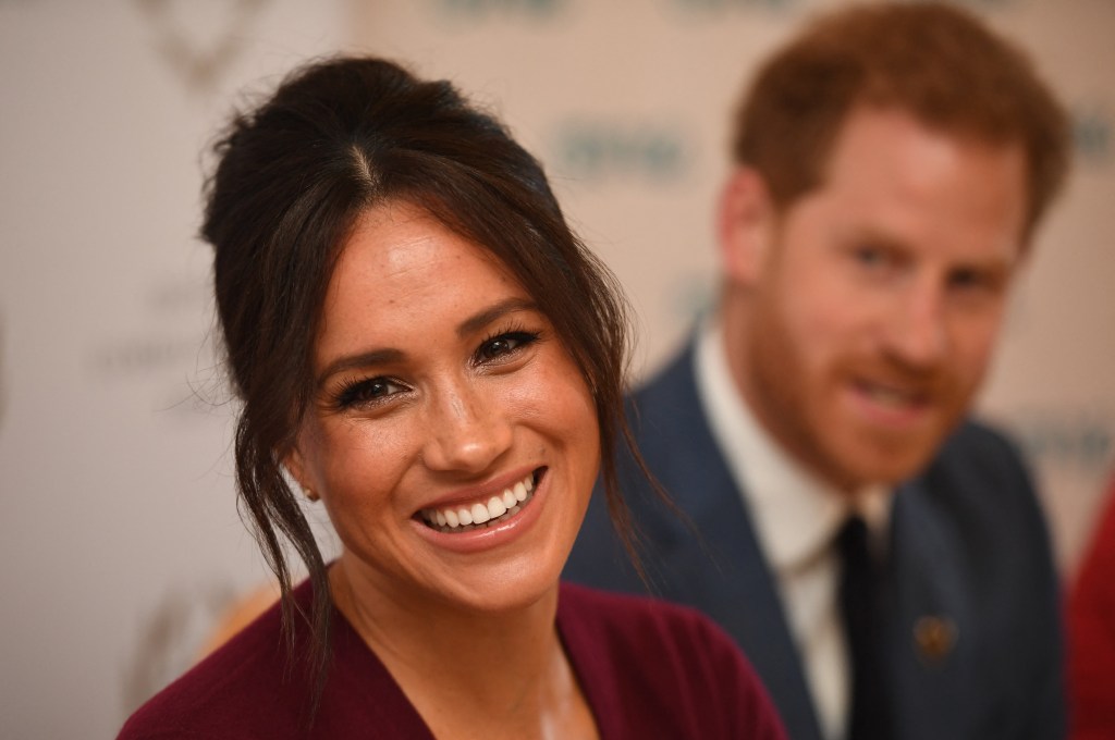 (FILES) In this file photo taken on October 25, 2019 Britain's Prince Harry, Duke of Sussex (R) and Meghan, Duchess of Sussex attend a roundtable discussion on gender equality with The Queens Commonwealth Trust (QCT) and One Young World at Windsor Castle in Windsor. - Queen Elizabeth II is saddened by the challenges faced by her grandson Prince Harry and his wife Meghan, and takes their allegations of racism in the royal family seriously, Buckingham Palace said on March 9, 2021. "The whole family is saddened to learn the full extent of how challenging the last few years have been for Harry and Meghan. The issues raised, particularly that of race, are concerning," the palace said in a statement released on the queen's behalf. (Photo by Jeremy Selwyn / POOL / AFP).