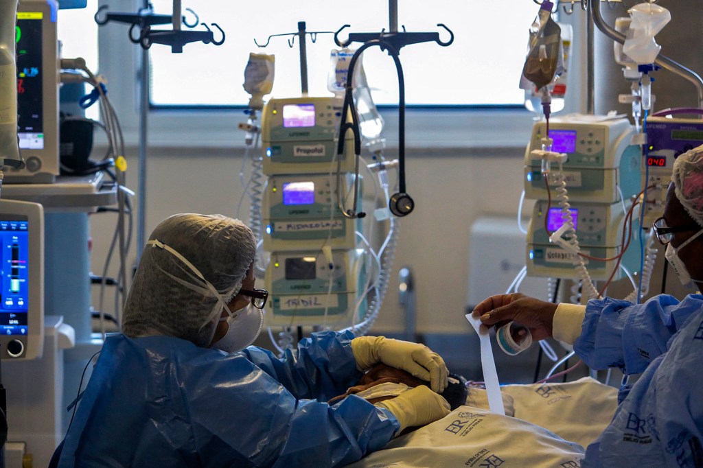 Health workers care for a COVID-19 patient who remains in the Intensive Care Unit of the Emilio Ribas Hospital in Sao Paulo, Brazil, on March 17, 2021. Sao Paulo reached an occupancy of 90% of ICU beds for the first time since the pandemic started.