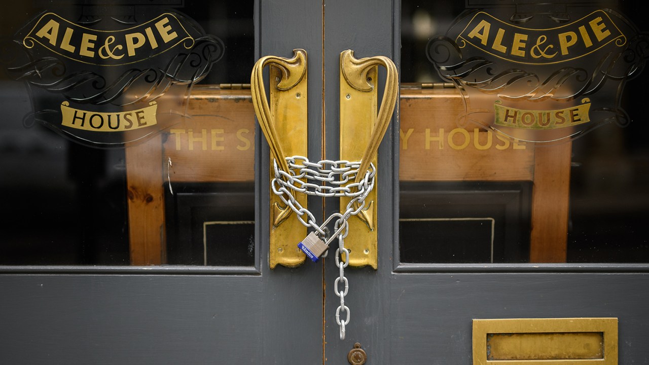 Um cadeado e uma corrente protegem a porta de um pub temporariamente fechado em Londres, na Inglaterra -