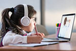 Little girl attending to online school class