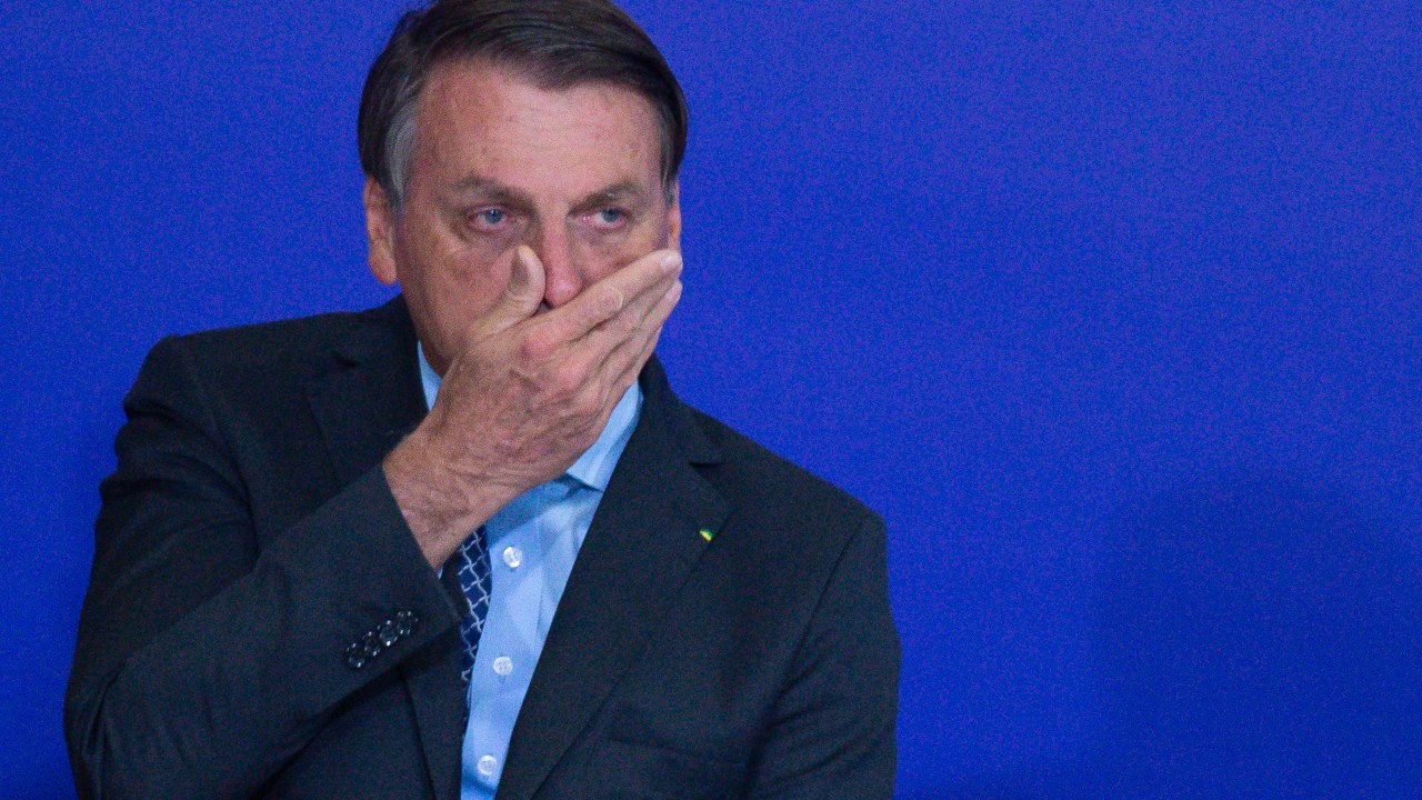 BRASILIA, BRAZIL - NOVEMBER 09: President of Brazil Jair Bolsonaro touches his face during Volunteering Alliance launch amidst the coronavirus (COVID-19) pandemic at the Planalto Palace on November 09, 2020 in Brasilia. Brazil has over 5.064,000 confirmed positive cases of Coronavirus and has over 162,397 deaths. (Photo by Andressa Anholete/Getty Images)
