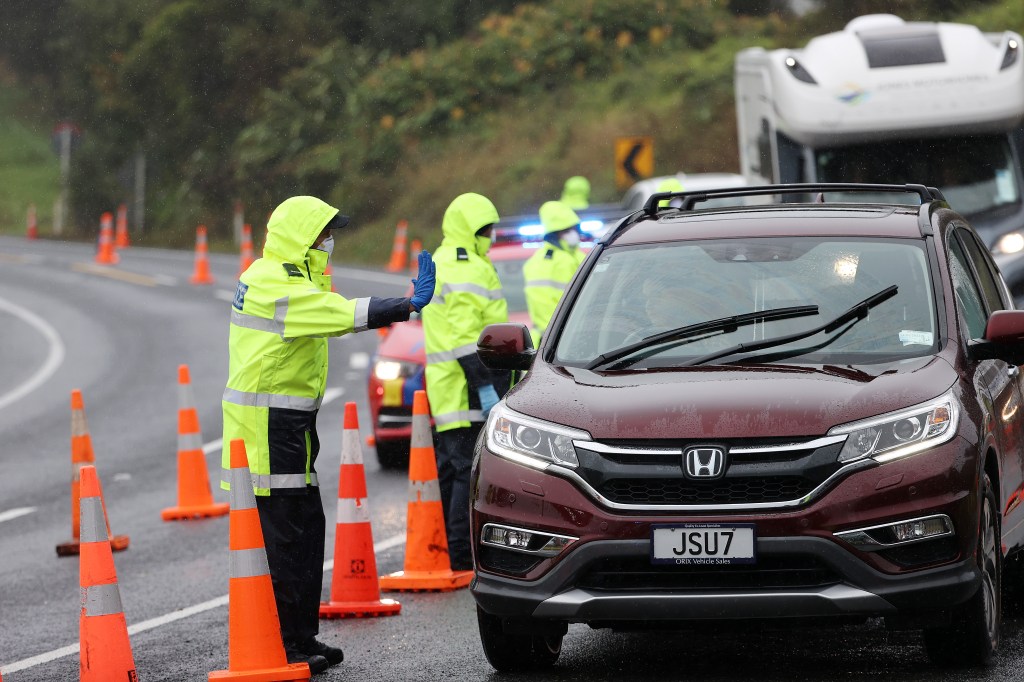 AUCKLAND, NEW ZEALAND - FEBRUARY 15: Police check reasons for travel to and from Auckland at a checkpoint north of Auckland on state highway one at Brynderwyn on February 15, 2021 in Auckland, New Zealand. Auckland is in alert level 3 COVID-19 lockdown for three days following the discovery of three new locally acquired coronavirus cases on Sunday. The rest of New Zealand has entered into level 2 restrictions as health authorities work to identify the source of infection. (Photo by Fiona Goodall/Getty Images)