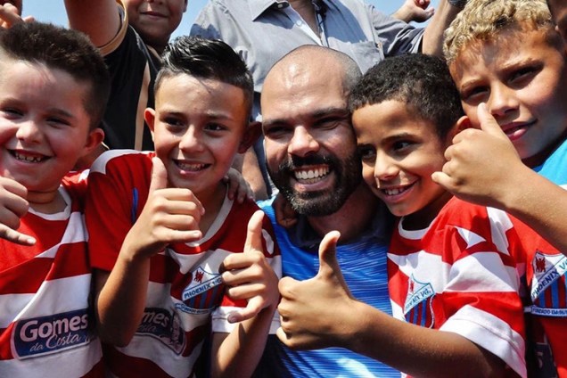 O prefeito de São Paulo posa para foto com crianças durante inauguração da Arena Cratera, na região de Parelheiros, em 2019 -