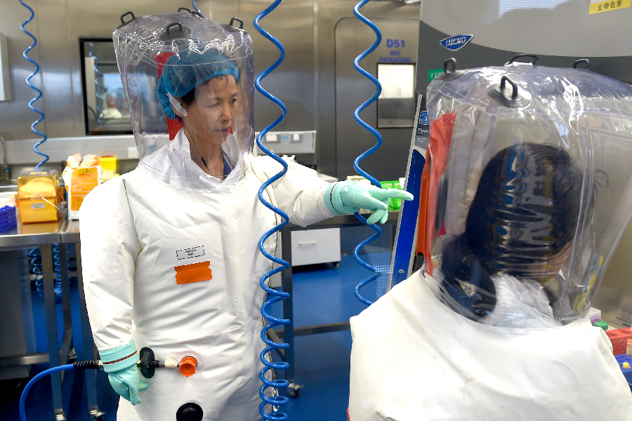 Virologist Shi Zheng-li, left, works with her colleague in the P4 lab of Wuhan Institute of Virology (WIV) in Wuhan in central China's Hubei province Thursday, Feb. 23, 2017.
