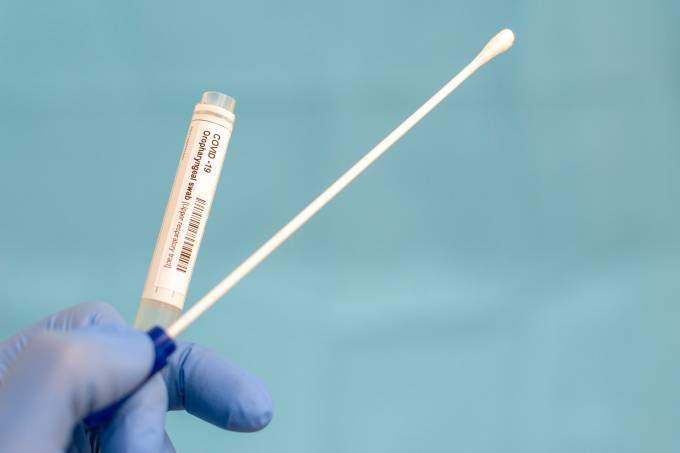Cotton swab and test tube for Coronavirus test (COVID-19)), macro image of medical equipment in hands of healthcare professional