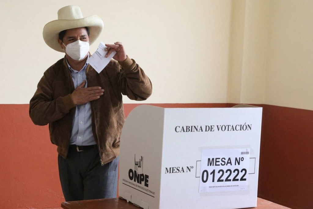 Pedro Castillo posa para os fotógrafos ao votar na eleição presidencial peruana -
