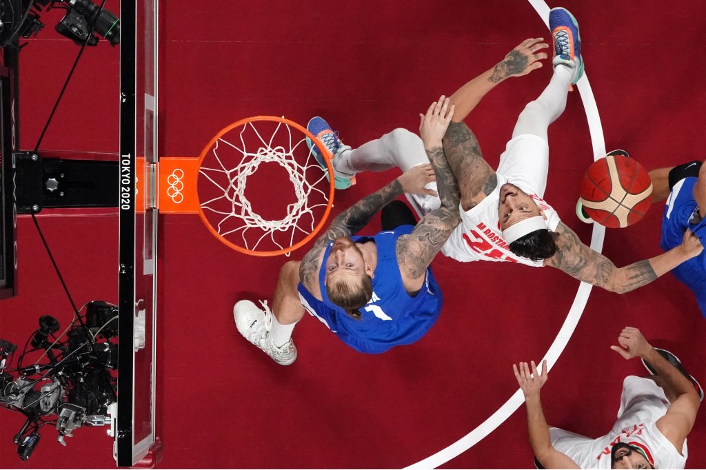 Iran's Michael Rostampour (2L) and Czech Republic's Patrik Auda (L) fight for the rebound in the men's preliminary round group A basketball match between Iran and Czech Republic during the Tokyo 2020 Olympic Games at the Saitama Super Arena in Saitama on July 25, 2021. (Photo by Brian SNYDER / POOL / AFP) / ìThe erroneous mention[s] appearing in the metadata of this photo by Brian Snyder has been modified in AFP systems in the following manner: [correcting spelling of first name of photographer from Bryan to Brian]. Please immediately remove the erroneous mention[s] from all your online services and delete it (them) from your servers. If you have been authorized by AFP to distribute it (them) to third parties, please ensure that the same actions are carried out by them. Failure to promptly comply with these instructions will entail liability on your part for any continued or post notification usage. Therefore we thank you very much for all your attention and prompt action. We are sorry for the inconvenience this notification may cause and remain at your disposal for any further information you may require.î