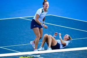 Brazil's Laura Pigossi (Bottom) and Brazil's Luisa Stefani celebrate after defeating Russia's Veronika Kudermetova and Russia's Elena Vesnina during the Tokyo 2020 Olympic Games women's doubles tennis match for the bronze medal at the Ariake Tennis Park in Tokyo on July 31, 2021. (Photo by Vincenzo PINTO / AFP)