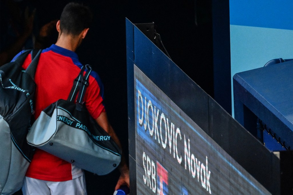 Serbia's Novak Djokovic leaves after losing to Spain's Pablo Carreno Busta the Tokyo 2020 Olympic Games men's singles tennis match for the bronze medal at the Ariake Tennis Park in Tokyo on July 31, 2021. (Photo by Vincenzo PINTO / AFP)