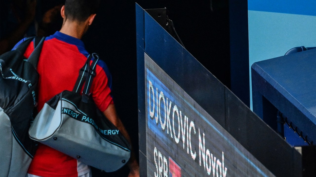 Serbia's Novak Djokovic leaves after losing to Spain's Pablo Carreno Busta the Tokyo 2020 Olympic Games men's singles tennis match for the bronze medal at the Ariake Tennis Park in Tokyo on July 31, 2021. (Photo by Vincenzo PINTO / AFP)