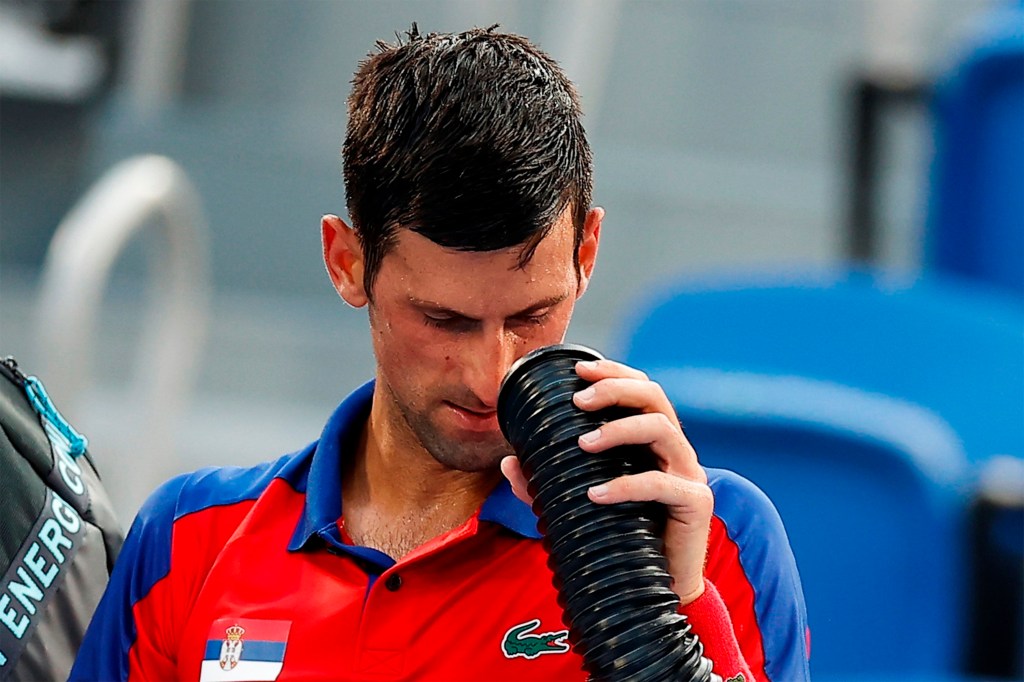 EVE3526. TOKIO, 28/07/2021.- El serbio Novak Djokovic se refresca debido a las altas temperaturas que se están registrando en las pruebas de tenis disputadas en los Juegos Olímpicos 2020, este miércoles en el Parque de Tenis de Ariake en Tokio (Japón). EFE/Juan Ignacio Roncoroni