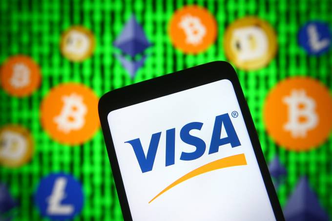 In this photo illustration, Visa logo is seen displayed on a