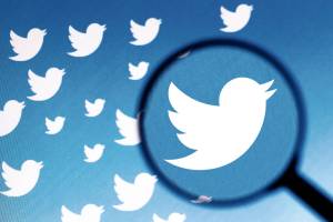 In this photo illustration a Twitter logo is seen on a