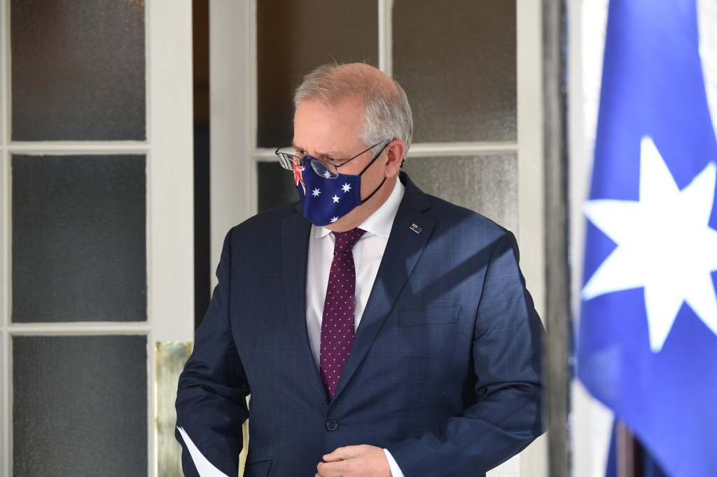 SYDNEY, AUSTRALIA - JULY 15: Prime Minister Scott Morrison wearing a face mask arrives for a press conference at Kirribilli House on July 15, 2021 in Sydney, Australia. Lockdown restrictions have been extended for at least a further two weeks as NSW continues to record new community COVID-19 cases. Residents of Greater Sydney, the Blue Mountains, the Central Coast and Wollongong are subject to stay-at-home orders with people are only permitted to leave their homes for essential reasons. Essential reasons include purchasing essential goods, accessing or providing care or healthcare, essential work, education or exercise. Exercise is restricted to within within the local government area and no further than 10km from home and with a maximum of two people per group. Browsing in shops is prohibited and only one person per household can leave home for shopping per day. Outdoor public gatherings are limited to two people, while funerals are limited to 10 people only. The restrictions are expected to remain in place until 11:59pm on Friday 30 July. (Photo by James D. Morgan/Getty Images)