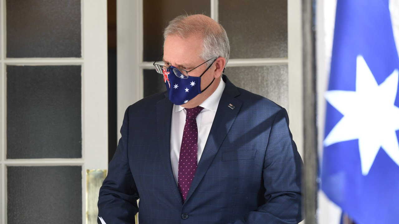 SYDNEY, AUSTRALIA - JULY 15: Prime Minister Scott Morrison wearing a face mask arrives for a press conference at Kirribilli House on July 15, 2021 in Sydney, Australia. Lockdown restrictions have been extended for at least a further two weeks as NSW continues to record new community COVID-19 cases. Residents of Greater Sydney, the Blue Mountains, the Central Coast and Wollongong are subject to stay-at-home orders with people are only permitted to leave their homes for essential reasons. Essential reasons include purchasing essential goods, accessing or providing care or healthcare, essential work, education or exercise. Exercise is restricted to within within the local government area and no further than 10km from home and with a maximum of two people per group. Browsing in shops is prohibited and only one person per household can leave home for shopping per day. Outdoor public gatherings are limited to two people, while funerals are limited to 10 people only. The restrictions are expected to remain in place until 11:59pm on Friday 30 July. (Photo by James D. Morgan/Getty Images)