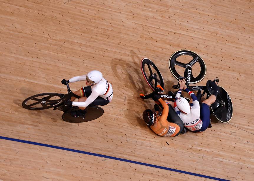 A holandesa Laurine van Riessen (laranja), cai junto com a britânica Katy Marchant durante corrida no ciclismo -