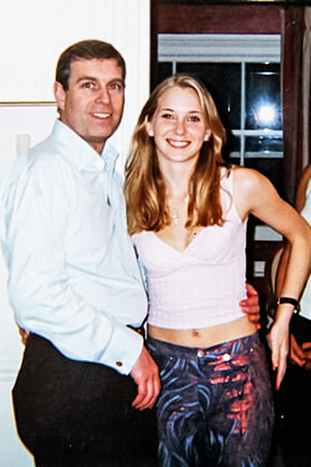 The infamous photograph of Prince Andrew smiling as he stands with his left arm around the waist of a young Virginia Roberts has dogged him for years. It is alleged to have been taken in early 2001