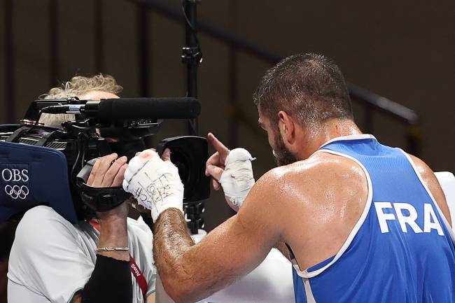 TOKYO, JAPAN - AUGUST 1, 2021: France's Mourad Aliev (R) stands in front of a cameraman after being disqualified for headbutting Team GB's Frazer Clarke (not pictured) in a men's super heavyweight (+91kg) quarterfinal boxing bout at Kokugikan Arena during the 2020 Summer Olympic Games. Frazer was announced the winner. Valery Sharifulin/TASS (Photo by Valery SharifulinTASS via Getty Images)