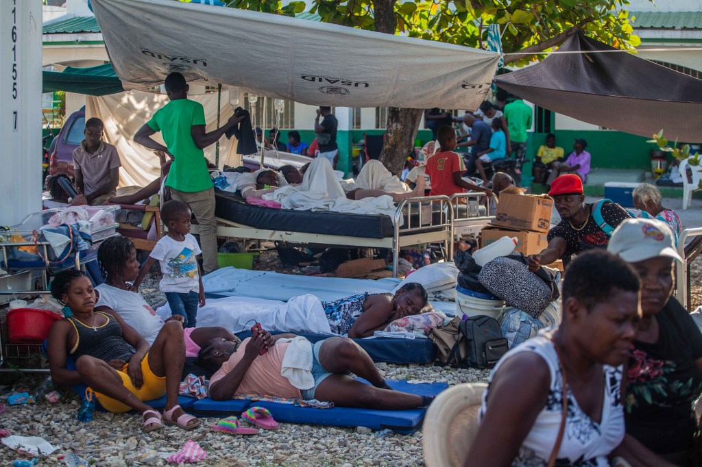 LES CAYES, HAITI - AUGUST 15: Haitians rest outdoors after a 7.2-magnitude earthquake on August 15, 2021 in Les Cayes, Haiti. Rescue workers have been working among destroyed homes since the quake struck on Saturday and so far there are 1,297 dead and 5.700 wounded. The epicenter was located about 100 miles west of the capital city Port-au-Prince. (Photo by Richard Pierrin/Getty Images)