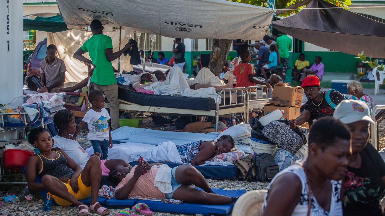 LES CAYES, HAITI - AUGUST 15: Haitians rest outdoors after a 7.2-magnitude earthquake on August 15, 2021 in Les Cayes, Haiti. Rescue workers have been working among destroyed homes since the quake struck on Saturday and so far there are 1,297 dead and 5.700 wounded. The epicenter was located about 100 miles west of the capital city Port-au-Prince. (Photo by Richard Pierrin/Getty Images)