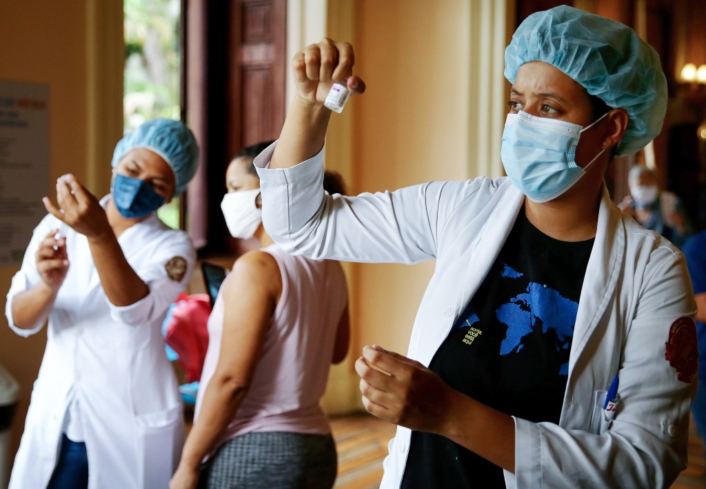 RIO DE JANEIRO, BRAZIL - MAY 24: Nurse-in-training Julia Ramos prepares to vaccinate a person at a COVID-19 vaccination clinic at Museu da Republica (Museum of the Republic) on May 24, 2021 in Rio de Janeiro, Brazil. COVID-19 has now killed more than 1 million people in Latin America and the Caribbean, with nearly half of those killed in Brazil. Only three percent of the population of Latin America have been fully vaccinated against COVID-19. Health experts are warning that Brazil should brace for a new surge of COVID-19 amid a slow vaccine rollout and relaxed restrictions. Nearly 450,000 people have been killed in Brazil by COVID-19, second only to the U.S. (Photo by Mario Tama/Getty Images)
