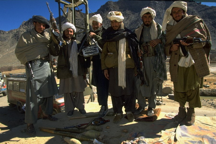Taliban fighters at checkpoint on road leading to radical Islamic faction's Charasiab HQ