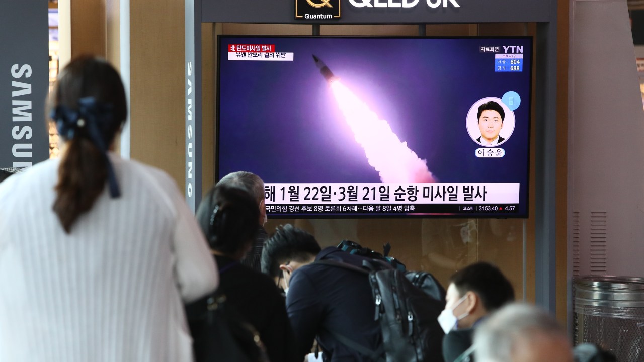 Sul-coreanos assistem a imagens de lançamento de mísseis da Coriea do Norte em estação de trem em Seul - 15/09/2021
