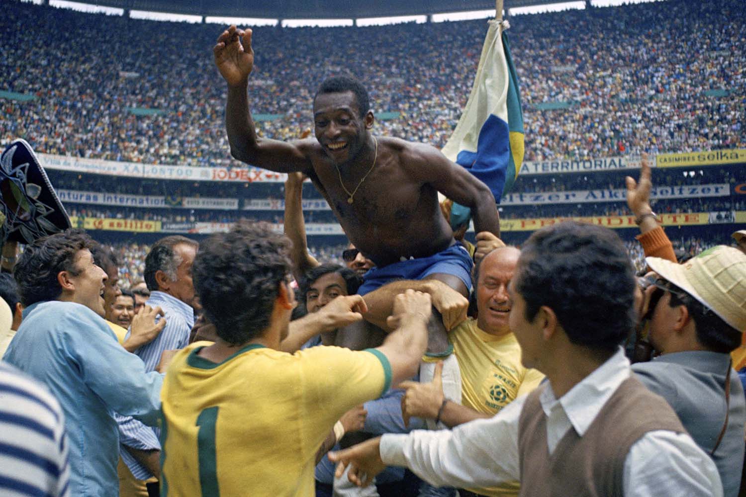 ** ADVANCE FOR WEEKEND EDITONS, MAY 29-30 ** FILE - In this June 21, 1970 file photo, Brazil's Pele is hoisted on shoulders of his teammates after Brazil won the World Cup final against Italy, 4-1, in Mexico City's Estadio Azteca. (AP Photo/File)