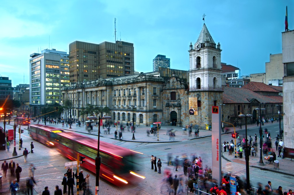 At the intersections of Avendia Jimenez and Carrera Septima, red Transmilenio buses pull into the Museum of Gold station in front of the16th century Iglesia de San Francisco, Bogota'soldest restored church.