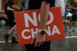 A man carrying a sign saying “No China” while taking part on a march in Taipei downtown